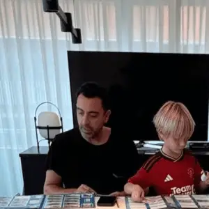 A social media phot of Xavi, with his son who is wearing a Mnachester United shirt